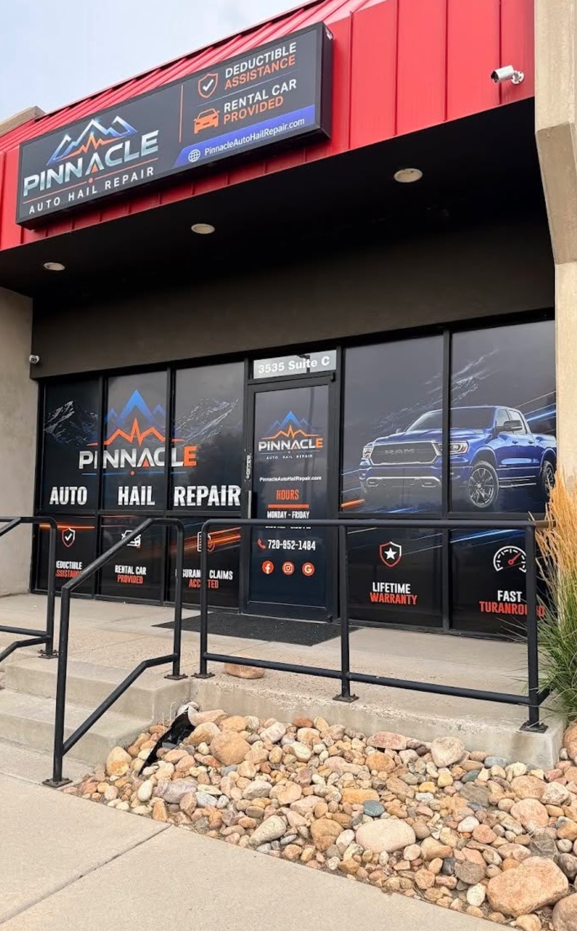 Pinnacle Auto Hail Repair storefront with printed window graphics and illuminated signage